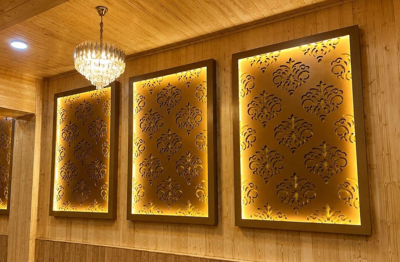 Backlit damask-pattern panels set into pine wall cladding under a crystal chandelier