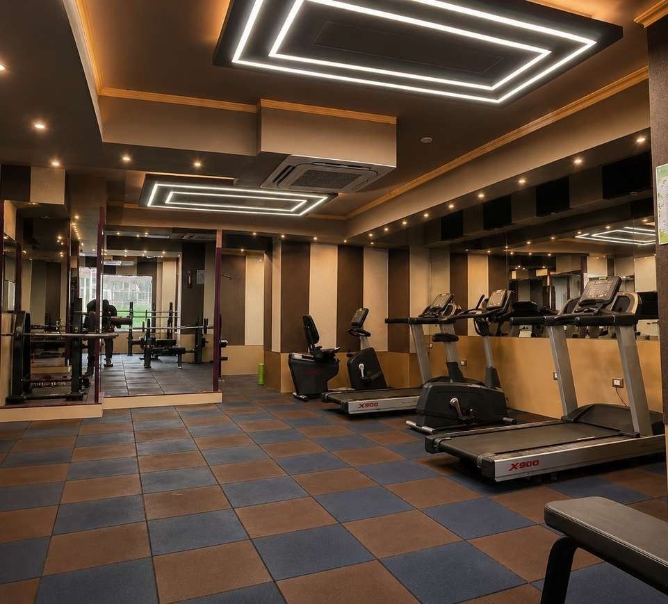 Row of treadmills and exercise bikes in the AIS Residency gymnasium